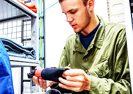 Cadet Flight Sergeant Levi Layh inspects a bear safety kit, checking its condition and ensuring expiry dates are valid, at Cold Lake Cadet Training Centre in Cold Lake, Alberta on July 9, 2026